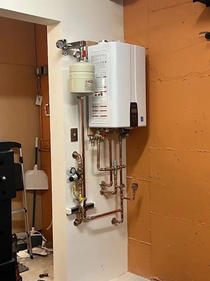 Plumbing technician inspecting water heater connections in Connerton